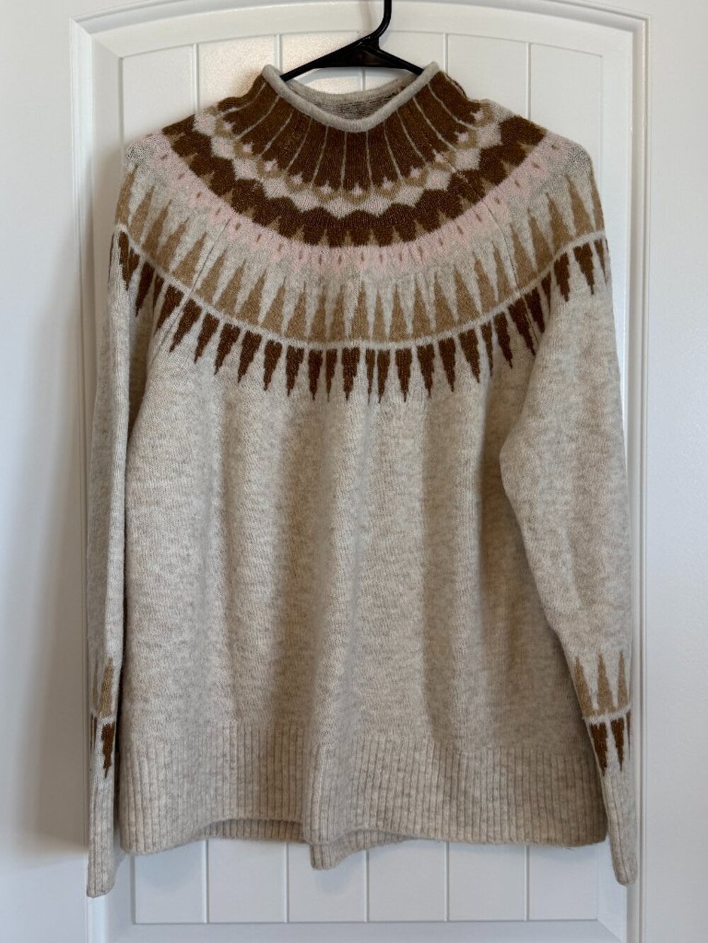 Cozy cream fair isle knit sweater with a geometric yoke pattern.